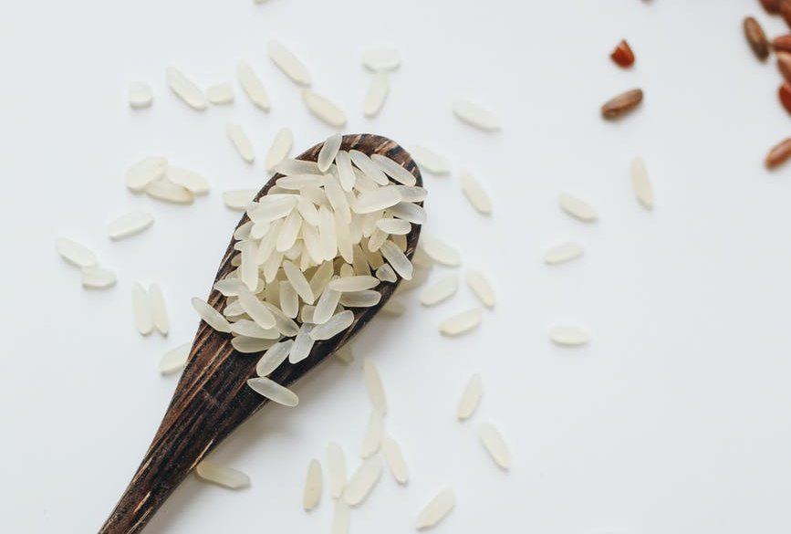photo of rice on wooden spoon